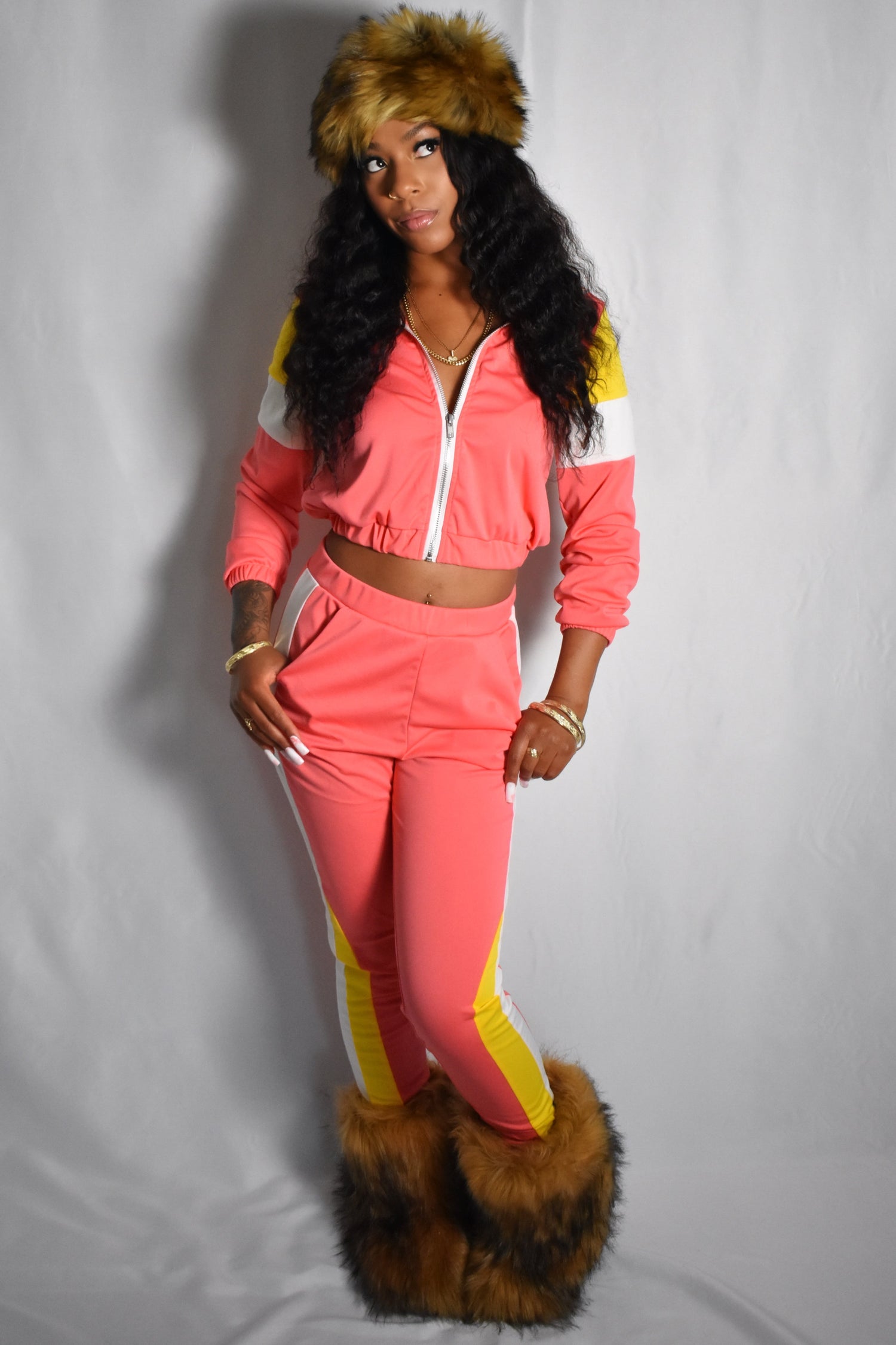 pink retro y2k tracksuit color block with yellow and white accents, brown faux fur boots, brown jumbo faux fur headband, two piece outfit set