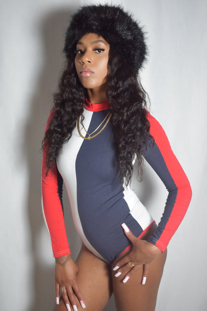 Arctic Rebel color block bodysuit in red, white, and blue with slim fit. Black frostbite jumbo faux fur headband.