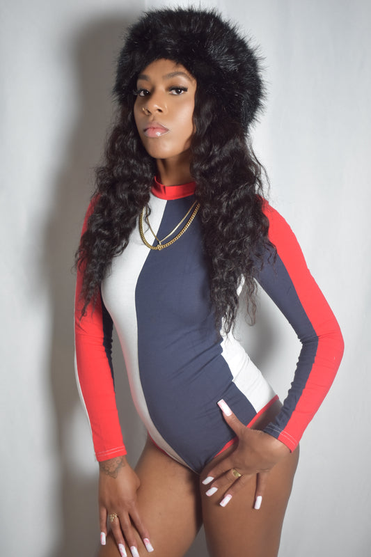 Arctic Rebel color block bodysuit in red, white, and blue with slim fit. Black frostbite jumbo faux fur headband.