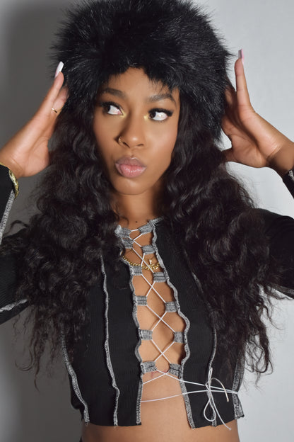 Front view of Loose Strings top with laced-up front and tied string design, thick material and string detail, black jumbo faux fur headband