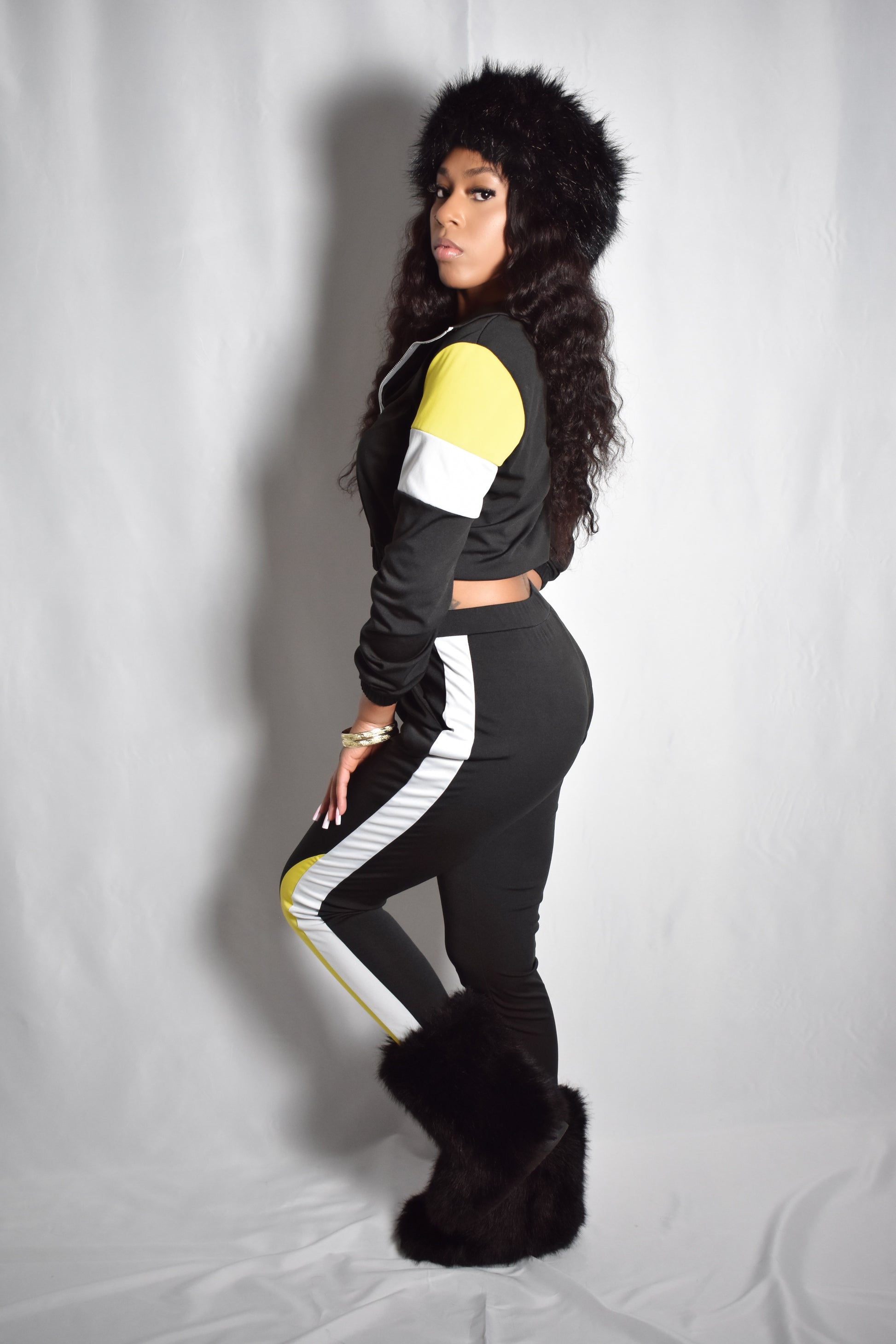 black retro y2k tracksuit color block with yellow and white accents, brown faux fur boots, brown jumbo faux fur headband, two piece outfit set