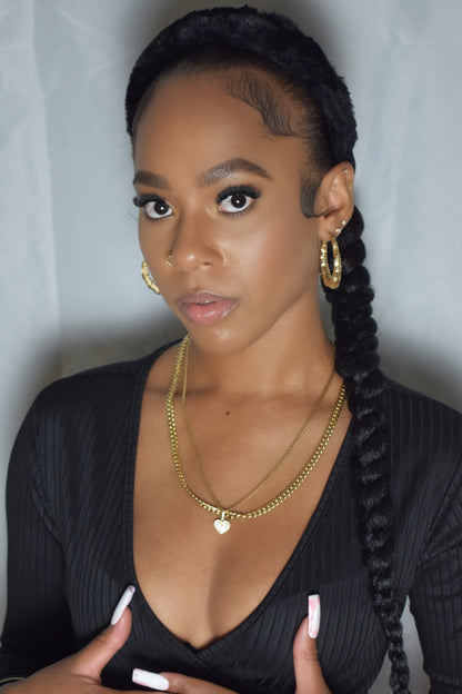 Woman with braided hair wearing a blue headband and gold jewelry. Snow Crown faux fur headband in soft plush material. Close-up of Snow Crown faux fur texture. Snow Crown faux fur headband styled as cute Y2K winter accessory. Snow Crown faux fur headband available in multiple colors.