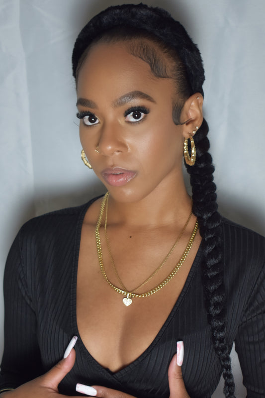 Woman with braided hair wearing a blue headband and gold jewelry. Snow Crown faux fur headband in soft plush material. Close-up of Snow Crown faux fur texture. Snow Crown faux fur headband styled as cute Y2K winter accessory. Snow Crown faux fur headband available in multiple colors.