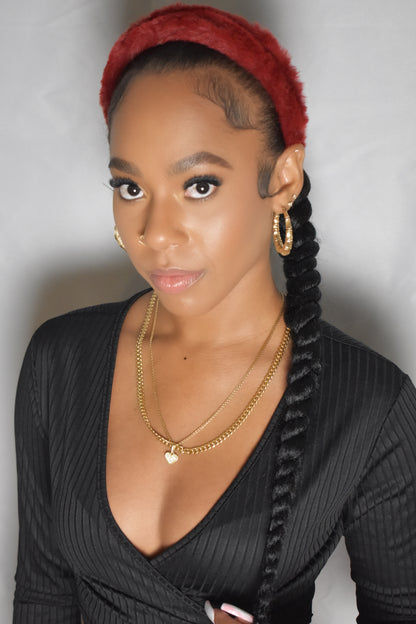 Woman with braided hair wearing a blue headband and gold jewelry. Snow Crown faux fur headband in soft plush material. Close-up of Snow Crown faux fur texture. Snow Crown faux fur headband styled as cute Y2K winter accessory. Snow Crown faux fur headband available in multiple colors.