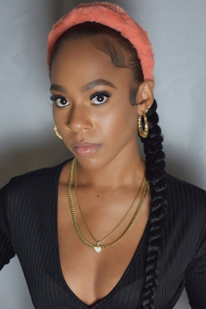 Woman with braided hair wearing a blue headband and gold jewelry. Snow Crown faux fur headband in soft plush material. Close-up of Snow Crown faux fur texture. Snow Crown faux fur headband styled as cute Y2K winter accessory. Snow Crown faux fur headband available in multiple colors.