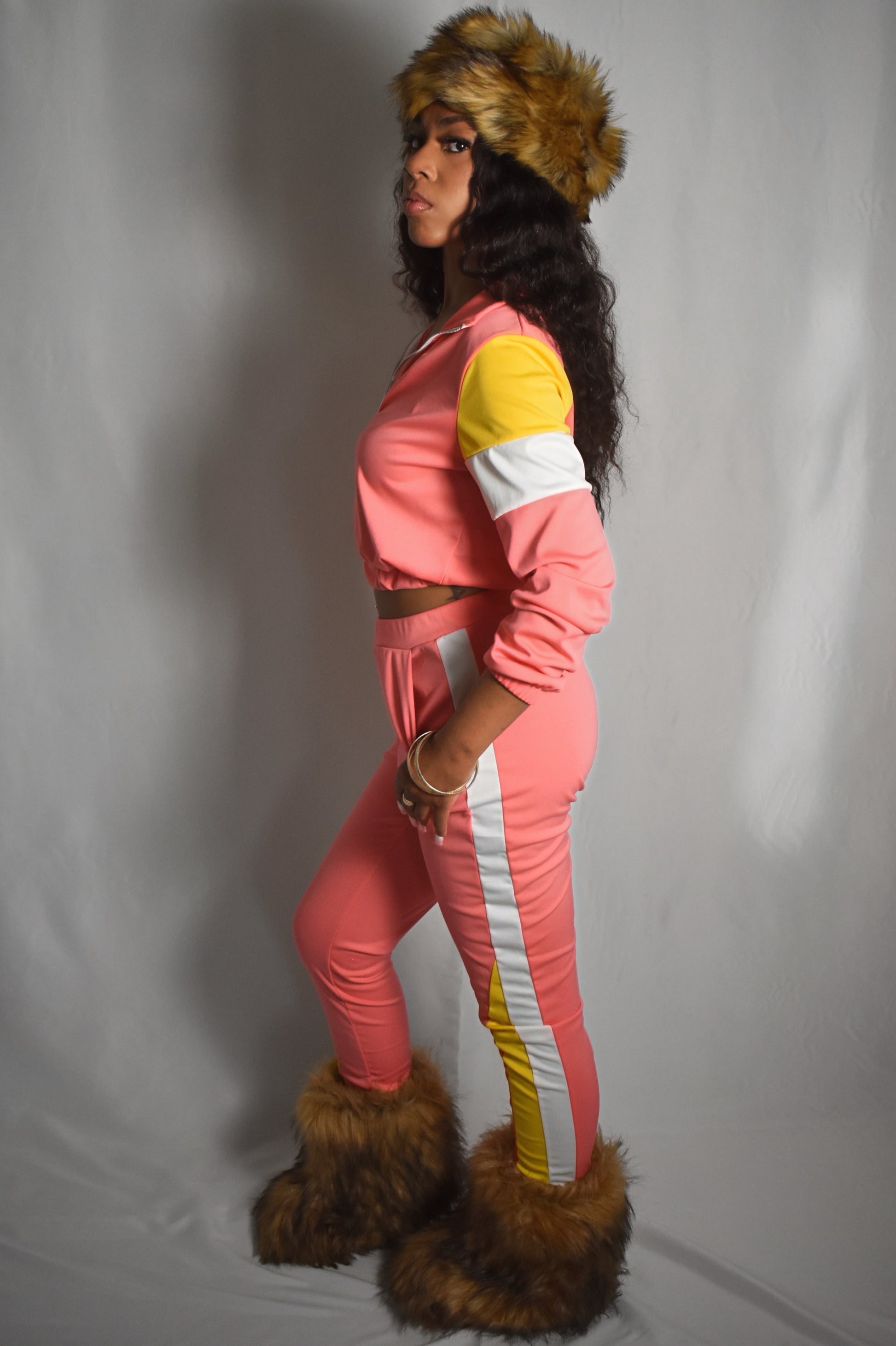pink retro y2k tracksuit color block with yellow and white accents, brown faux fur boots, brown jumbo faux fur headband, two piece outfit set