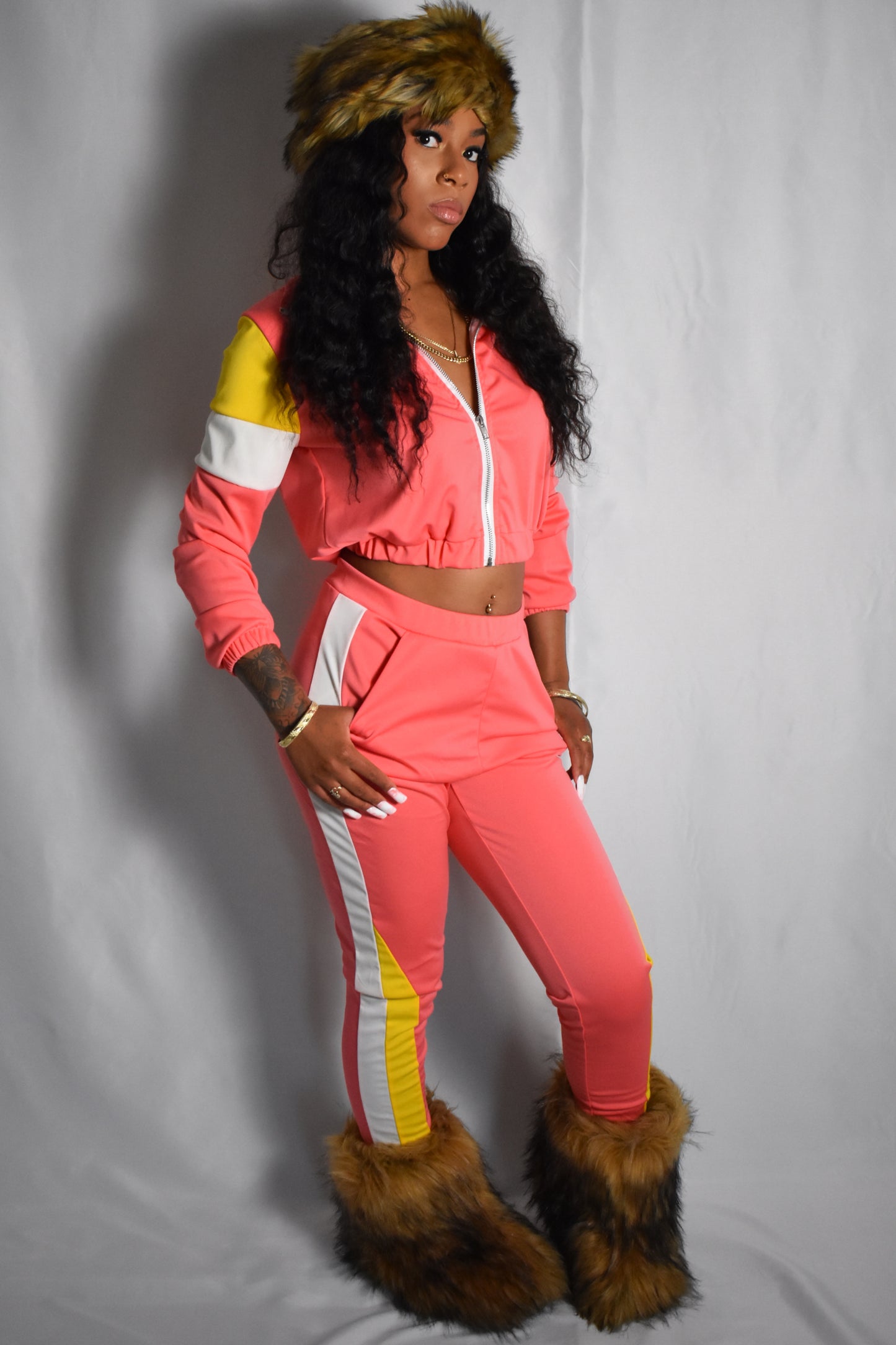 pink retro y2k tracksuit color block with yellow and white accents, brown faux fur boots, brown jumbo faux fur headband, two piece outfit set